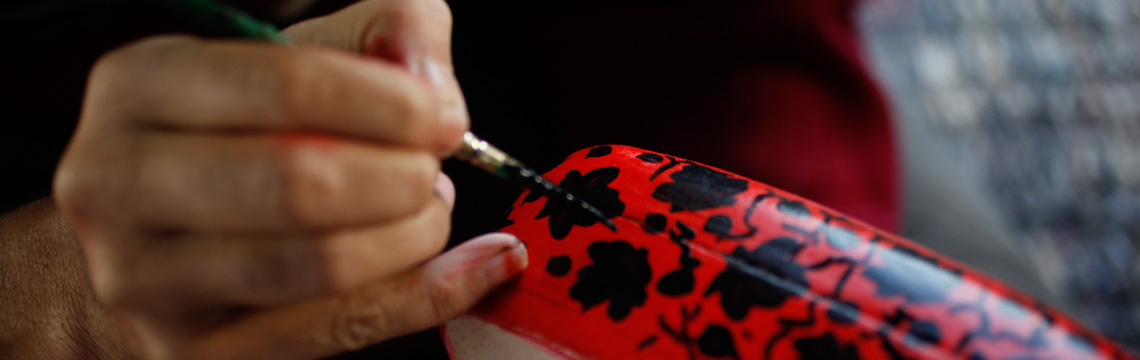 Close-up of a Kashmiri artist painting a papier mache box for the Booja-Booja special artist's gift collection