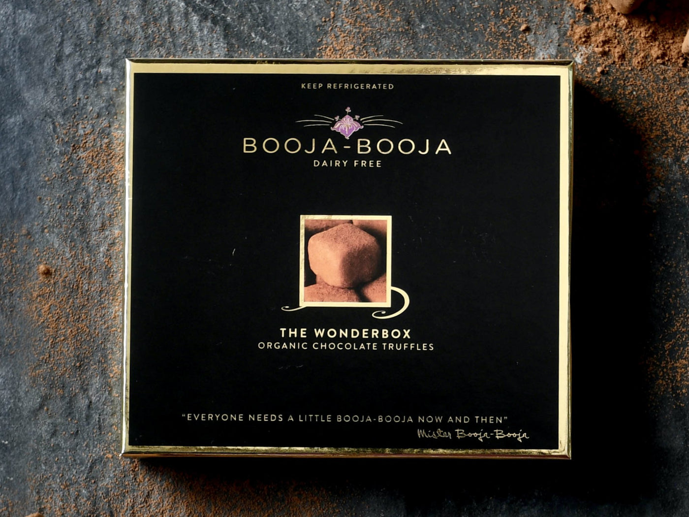 The Wonderbox, the ultimate Booja-Booja gift collection of vegan and organic chocolate truffles, photographed on a slate background with loose truffles around.